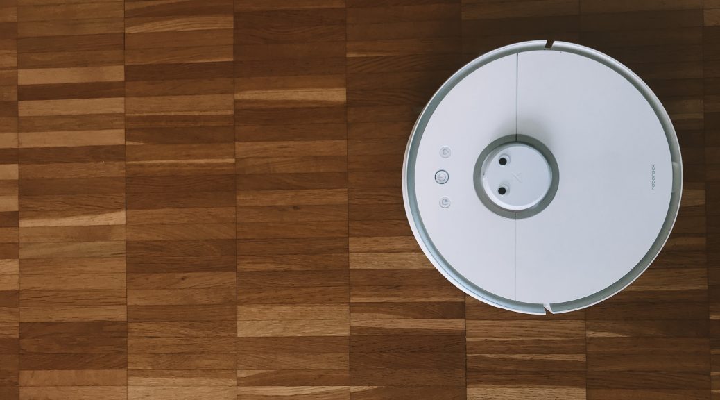 white Roomba robot on wooden floor